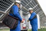 Two Service Engineers or electrician working on checking transformer site and solving problem for green energy solar power plant operation. Technician maintenance solar cells on Solar Energy Plant.