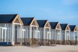 A beautiful shot of resting cabins on a sand beach