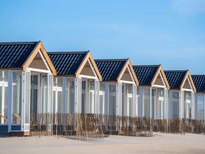 A beautiful shot of resting cabins on a sand beach